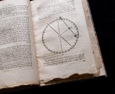 Detail of a printed text shows an astronomical circular diagram and text in English.