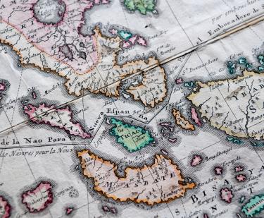 Detail of a pink, orange, and blue colored, engraved map shows islands of Philippines such as "Masbate" and "Ticao." Other details include a line partially labelled "de la Nao para la Nueva Espanna."