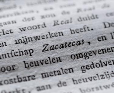 Detail of a printed book shows text in Dutch, with the Mexican state "Zacatecas" written in italics.