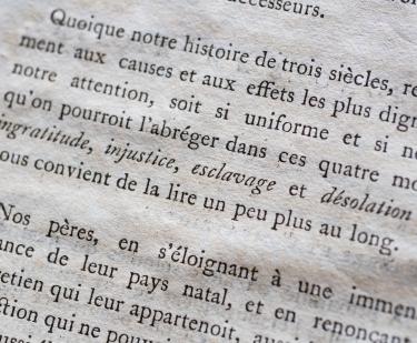 Detail of a printed book shows text in French.