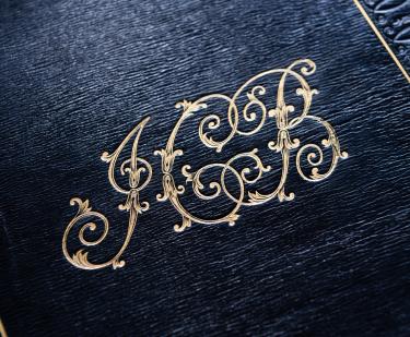 Detail of gold JCB stamp on black binding.
