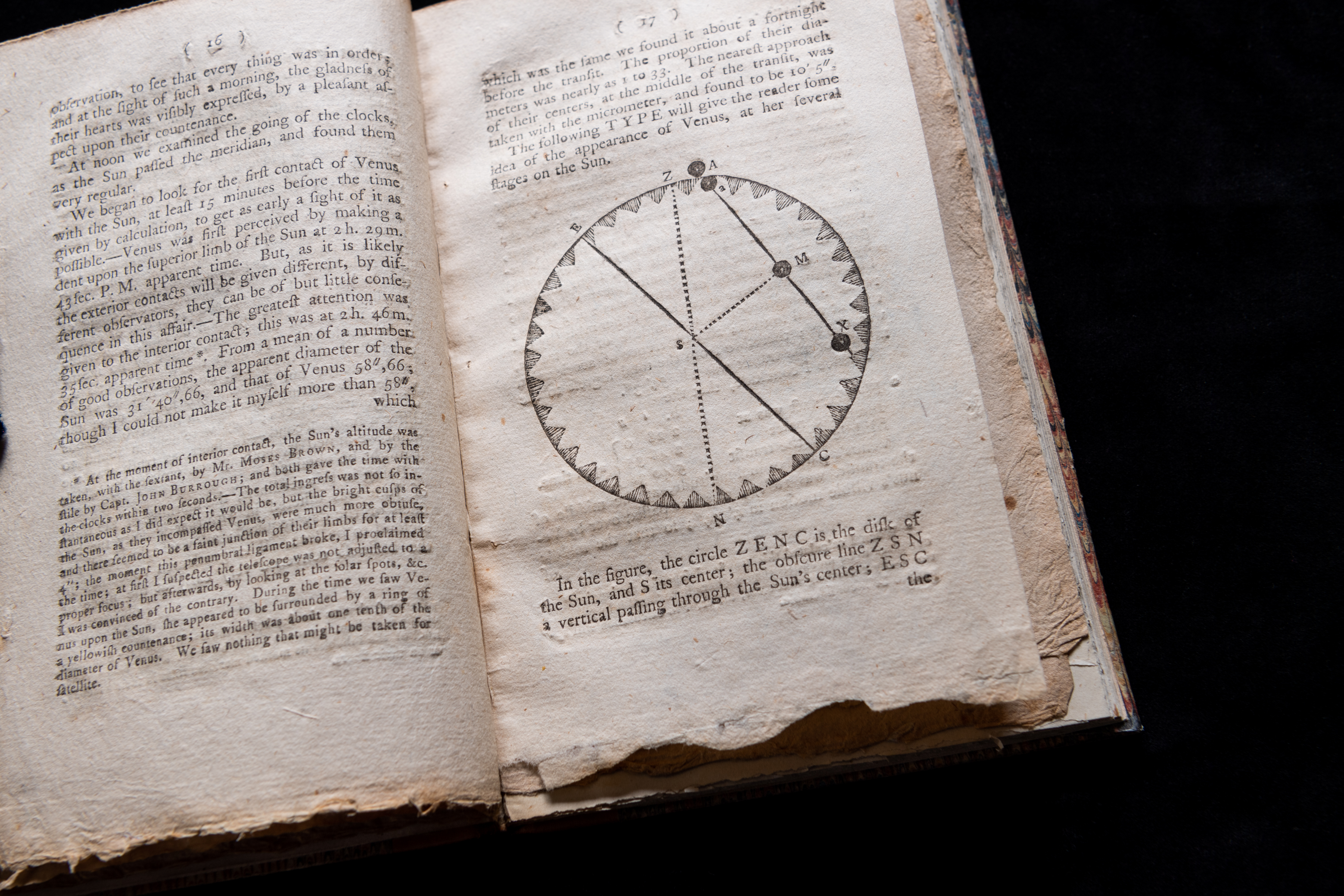 Detail of a printed text shows an astronomical circular diagram and text in English.