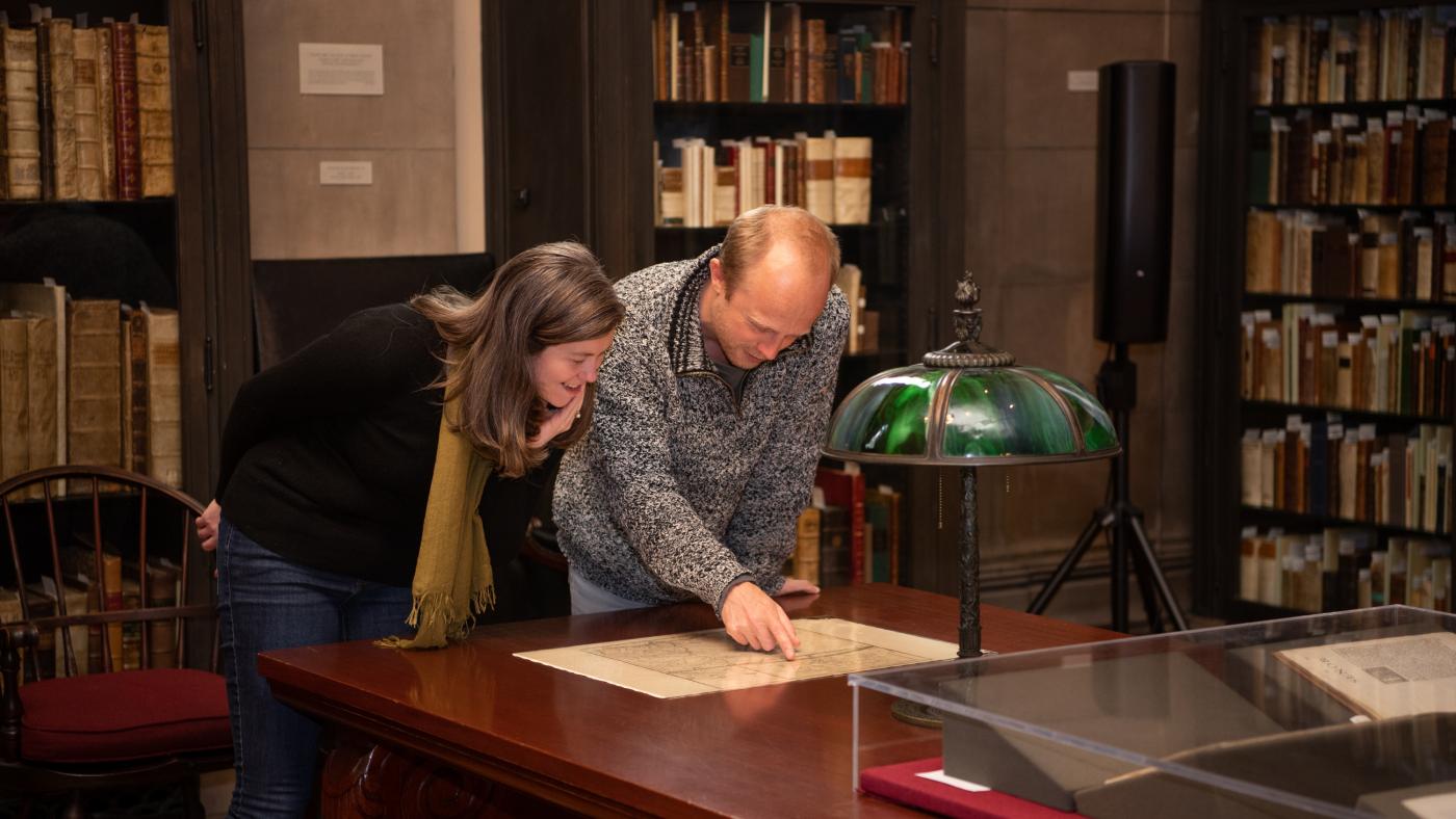 JCB Fellows Hannah Knox Tucker and Arthur Weststeijn consult a map in the reading room