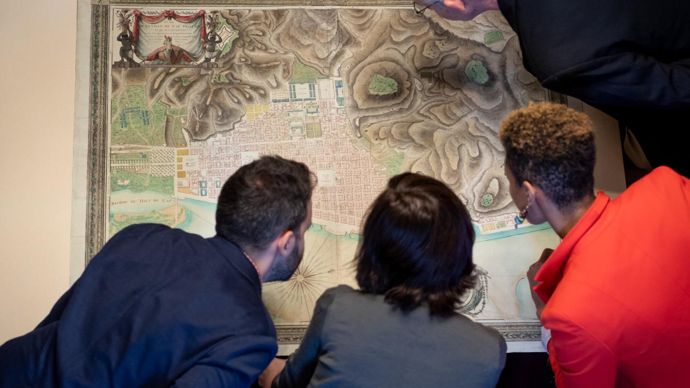 four researchers consult a large map