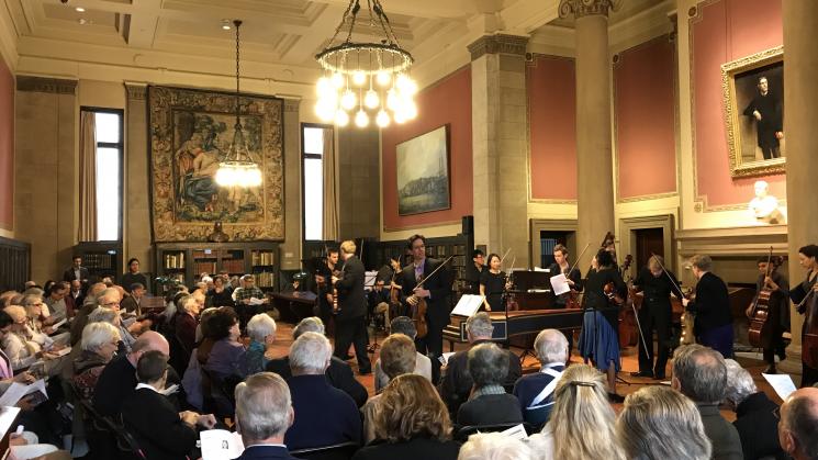 classical musicians perform in front of a large audience in the Library's reading room