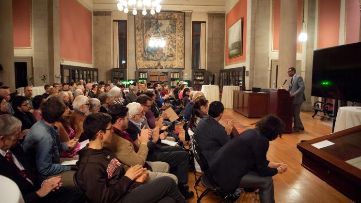 image of Dr. Herman Bennett speaking to an audience at the JCB