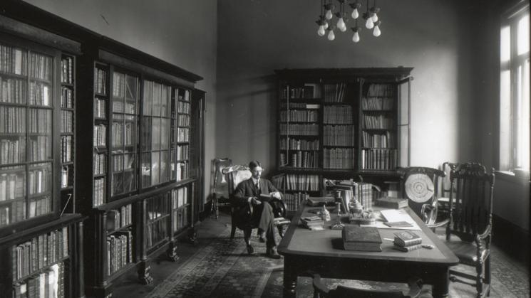 George Parker Winship in Library surrounded by books