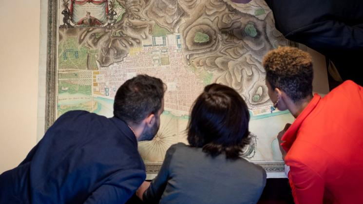 Four researchers examine a map