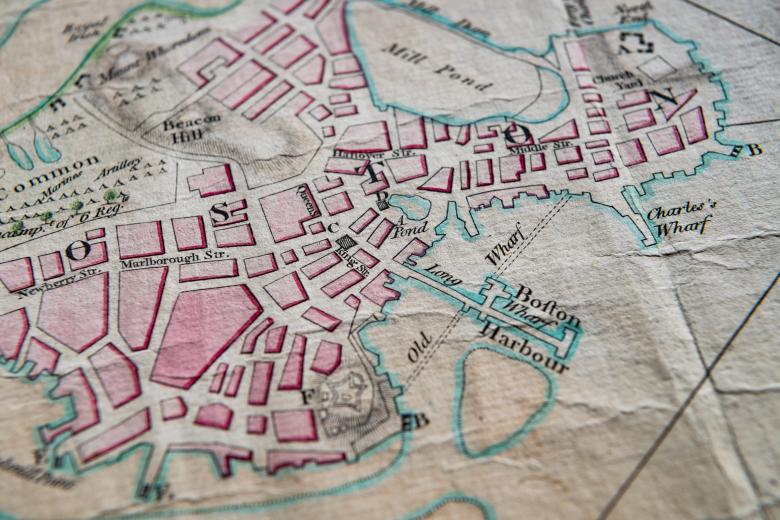 Detail of a hand colored, engraved map of Boston, Massachusetts shows details such as "Boston Harbor," "Mill Pond," and "Charles's Wharf." Pink, green, and blue colors help differentiate geographical features.