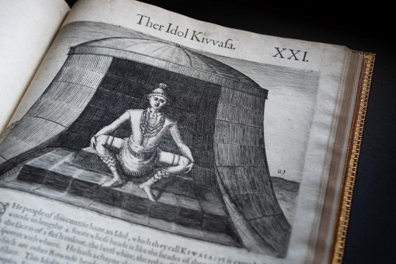 Detail of a printed book shows sketch of a person squatting.