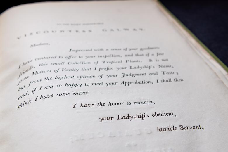 Detail of a printed book shows a dedication page written in English with the sign-off reading "I have the honor to remain, your Ladyship's obedient, humble Servant."