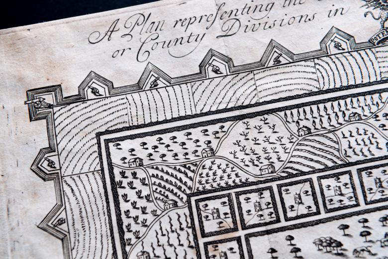 Detail of an engraved map of Azilia shows farmland, forest, and squares to represent farms. Manuscript notation at the top in English is partially visible.