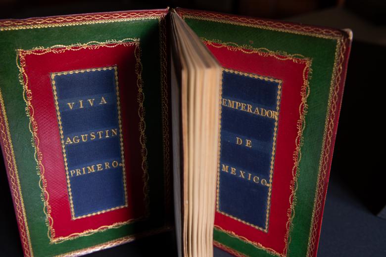 Printed book bound in red and green Morocco and blue silk with text in Spanish reading "Viva Agustin Primero" on the inner front cover and "emperador de Mexico" on the inner back cover.
