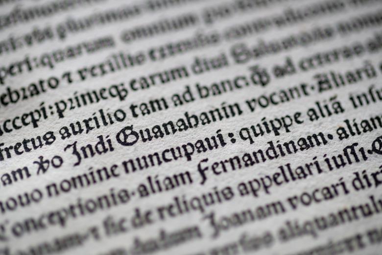 Detail of a printed page shows text in Latin.