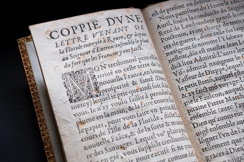 Detail of a printed book shows French text.