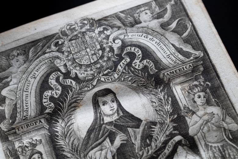 Detail of a printed book shows a decorated title page depicting an illustration of Sor Juana, angels, indigenous people, and text in Spanish and Latin.