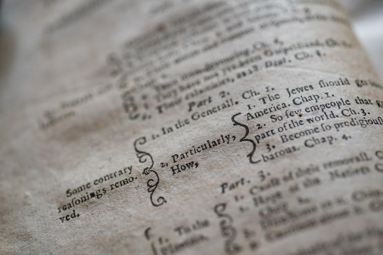 Detail of a printed book shows with text in English organized with brackets .