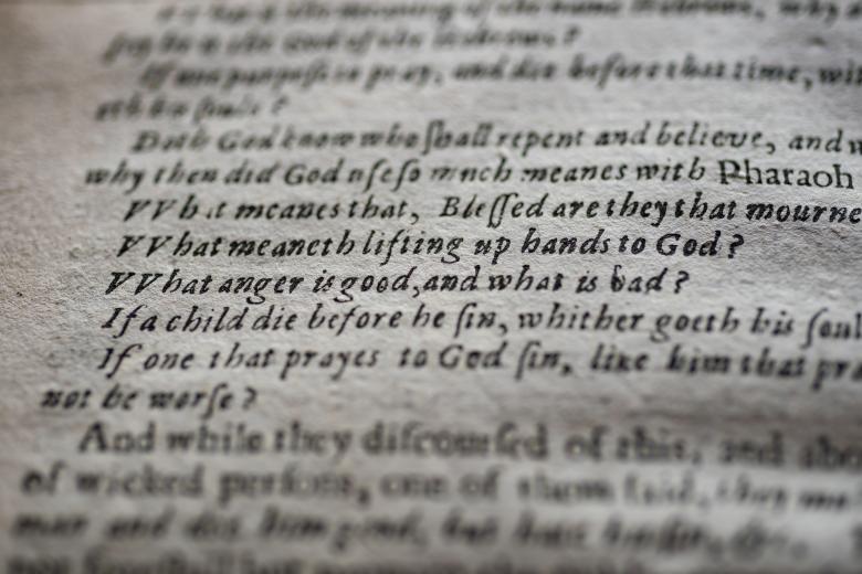 Detail of a printed book shows text in English listing a series of questions.