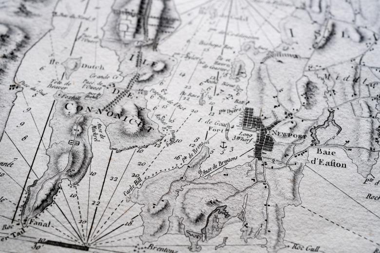 Detail of a printed atlas shows a portion of a map with labels in French and numbers indicating depth of water.