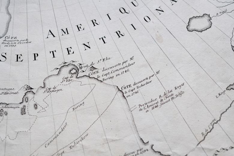 Detail of a printed map shows latitude and longitude lines and text in French such as "Commandeur Bering."