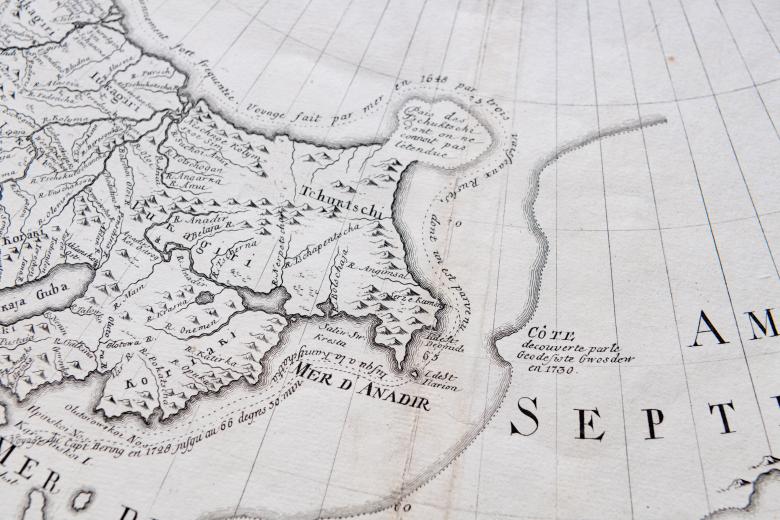 Detail of a printed map shows latitude and longitude lines and text in French such as "Mer d'Anadir."