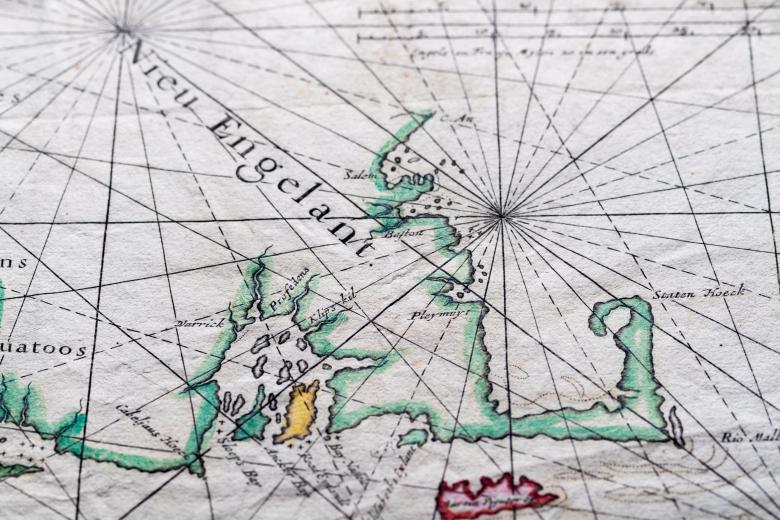Detail of a colored engraved map shows latitude and longitude lines and label in English over New England written as "Nieu Engelant."