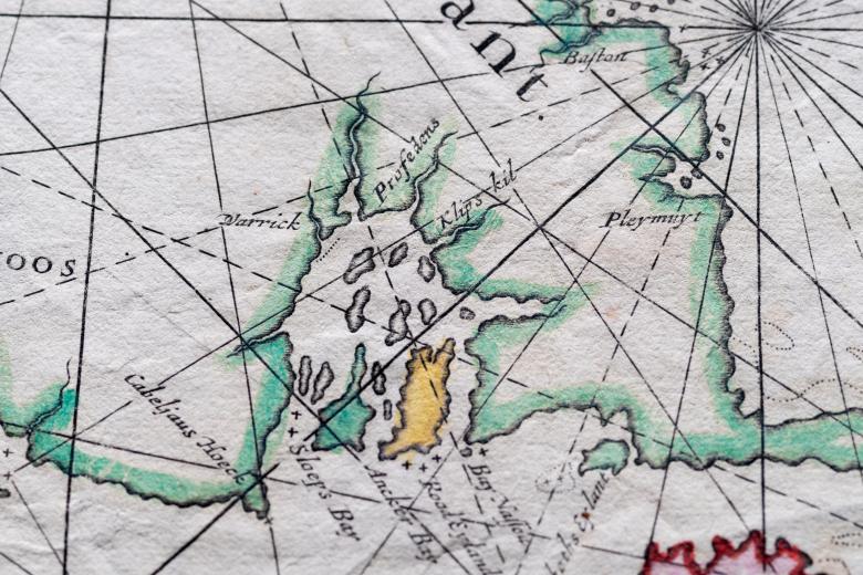Detail of a colored engraved map shows latitude and longitude lines and labels in English for Providence, written as "Profedens," and Warwick, written as "Warrick."