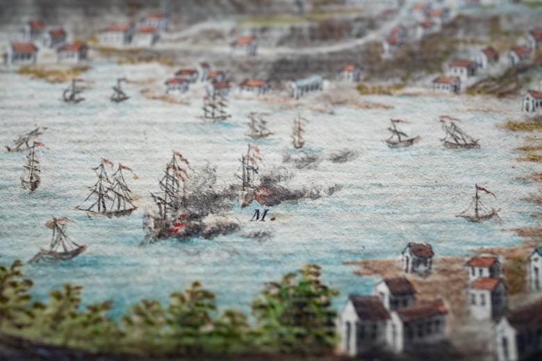 Detail of a hand colored, engraved print of Grenada shows a scene of naval warfare, as seen by smoke engulfing one ship.