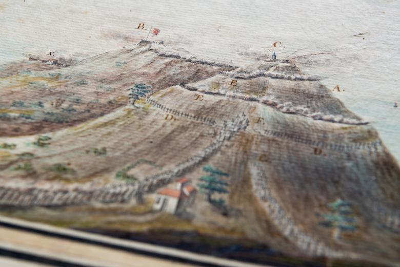 Detail of a hand colored, engraved print of Grenada shows two hills labelled with letters.