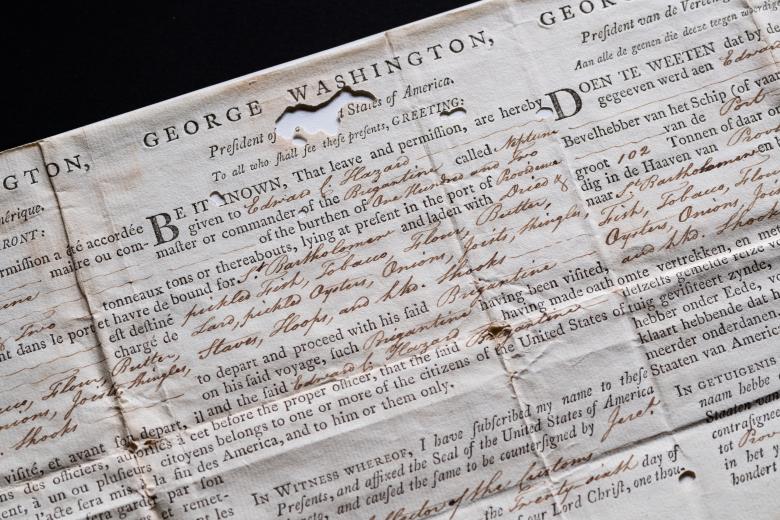 Detail from a weathered printed document, that includes manuscript inscriptions, shows text in English from the president of the united states.