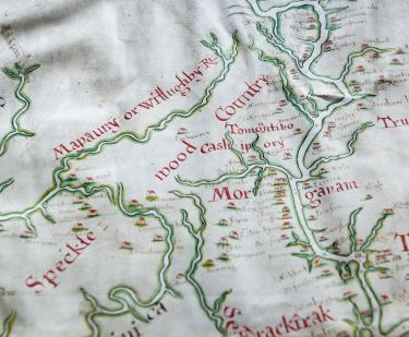 Detail of hand colored, manuscript map shows rivers (outlined in green) and labels written in red ink. Near the large, red letters reading "Mor" there is a plantation notable for being labeled "Jews." Other plantations are labeled with surnames.