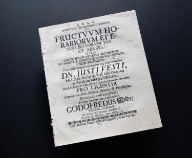 Detail of a printed book shows a title page with text in Latin.