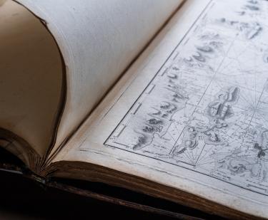 Detail of a printed atlas shows a full-page map.