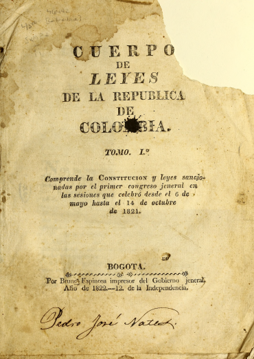 Detail of a printed document shows text in Spanish reading "Cuerpo de leyes de la republica de Colombia." The page is missing the top right corner and the tone of the paper shows sign of wear. Manuscript autograph at the bottom of the page.