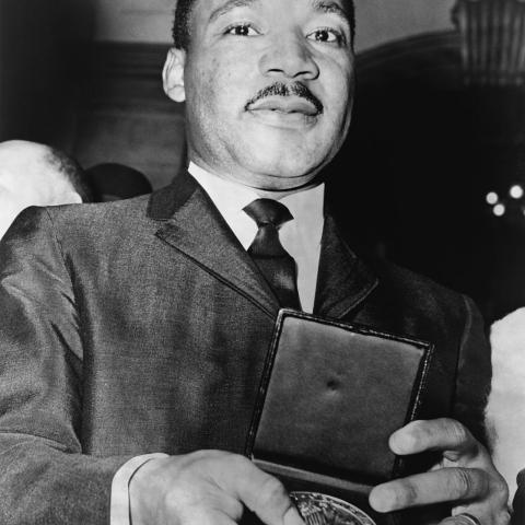Martin Luther King, Jr. showing his medallion received from Mayor Wagner