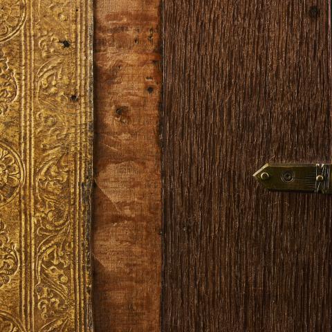 The image shows the cover of a book featuring various wooden panels in different tones.
