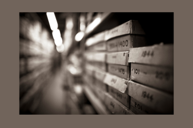 The image shows a row of boxes in an archive.